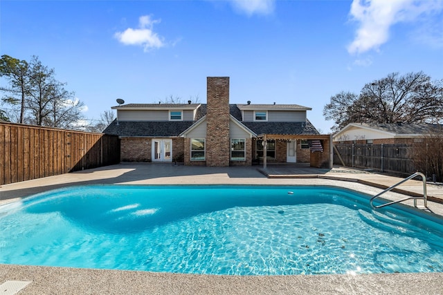 view of pool featuring a patio and french doors