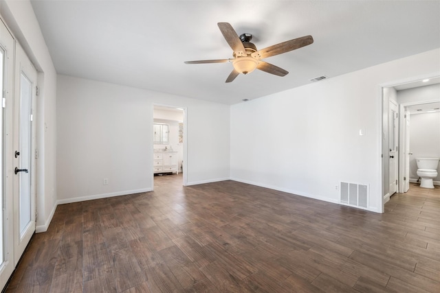 spare room featuring dark wood-type flooring and ceiling fan