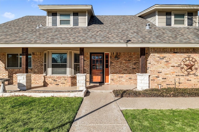 view of front of house with covered porch and a front lawn