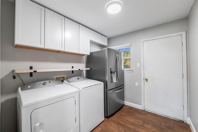 laundry area with cabinets, dark hardwood / wood-style floors, and washing machine and dryer