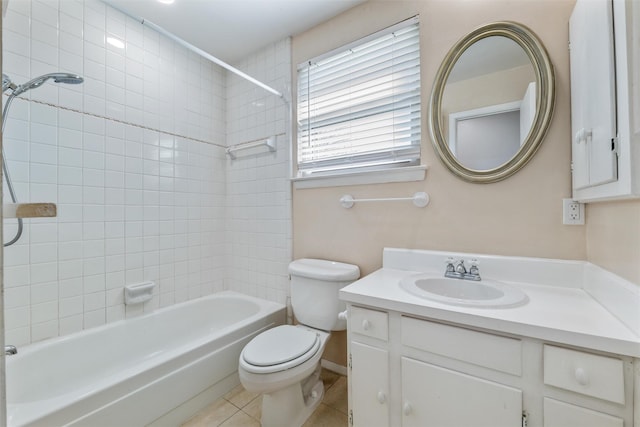 full bathroom featuring vanity, tiled shower / bath, tile patterned floors, and toilet