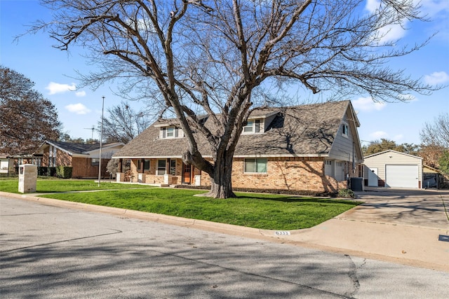 cape cod home with an outbuilding, a garage, a front lawn, and central air condition unit