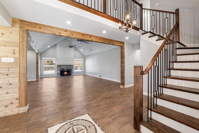 unfurnished living room featuring beamed ceiling, ceiling fan, dark hardwood / wood-style floors, and high vaulted ceiling