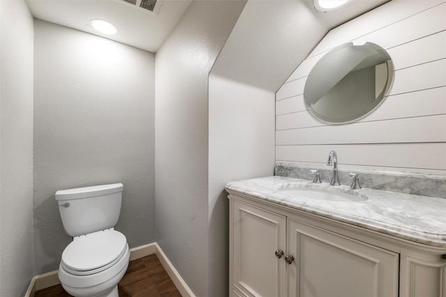 bathroom with vanity, hardwood / wood-style floors, and toilet