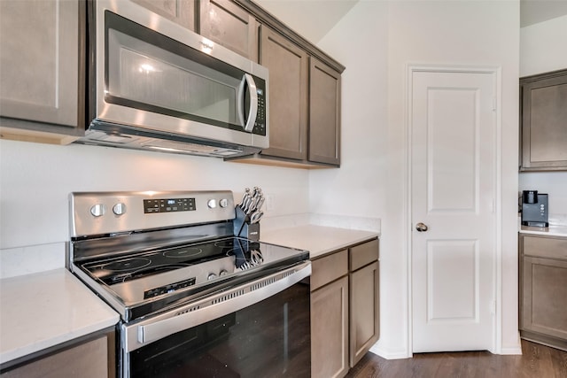 kitchen with dark wood-type flooring and stainless steel appliances