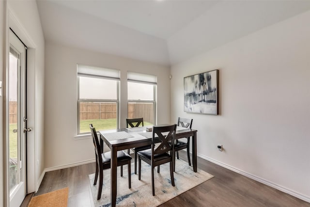 dining space with dark hardwood / wood-style flooring