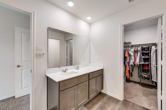 bathroom with vanity and hardwood / wood-style floors