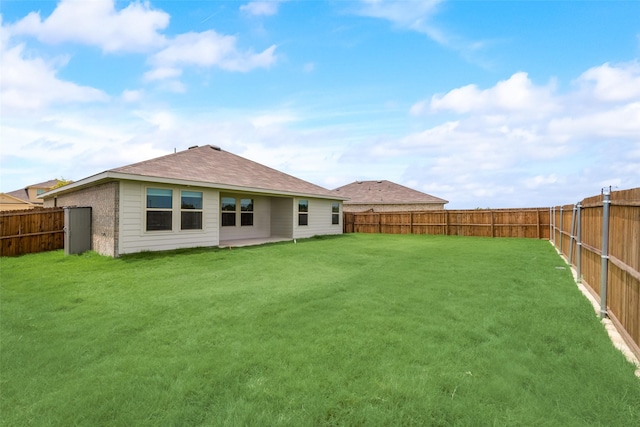 rear view of house with a yard