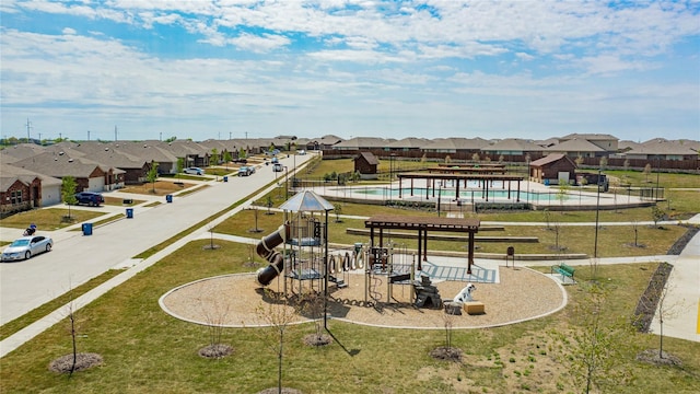 surrounding community featuring a playground and a lawn