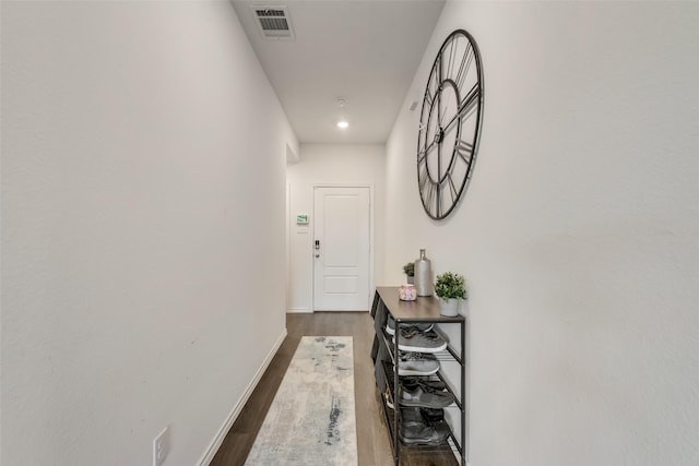 hallway with dark hardwood / wood-style flooring