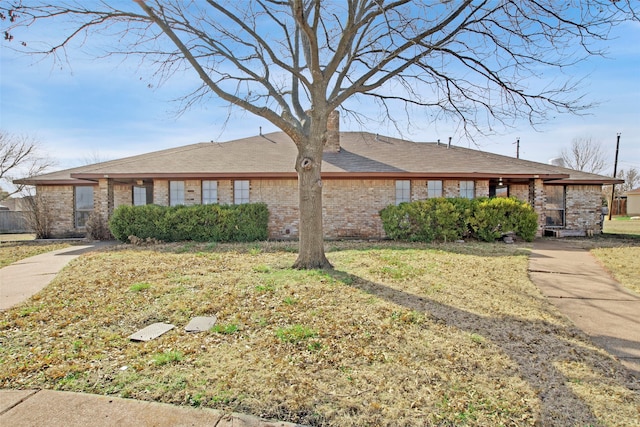 ranch-style house with a front lawn