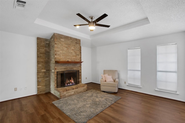 unfurnished room with dark hardwood / wood-style floors, a tray ceiling, and a textured ceiling