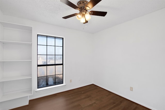 unfurnished room with ceiling fan, dark hardwood / wood-style floors, and a textured ceiling