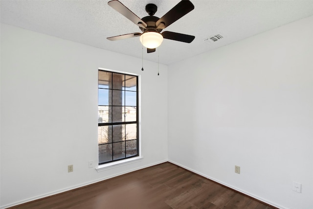 empty room with ceiling fan, a textured ceiling, and dark hardwood / wood-style flooring