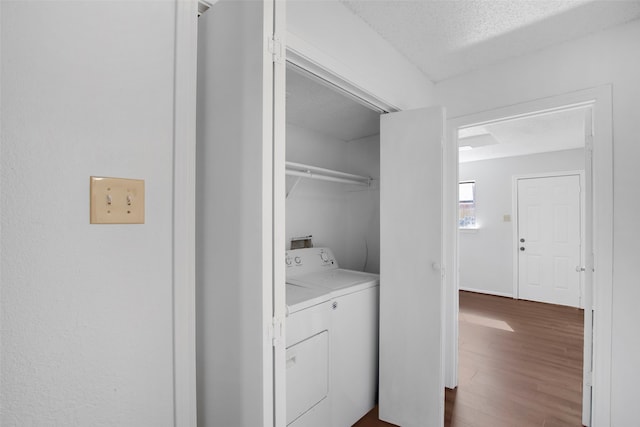 washroom featuring washer / clothes dryer, hardwood / wood-style flooring, and a textured ceiling