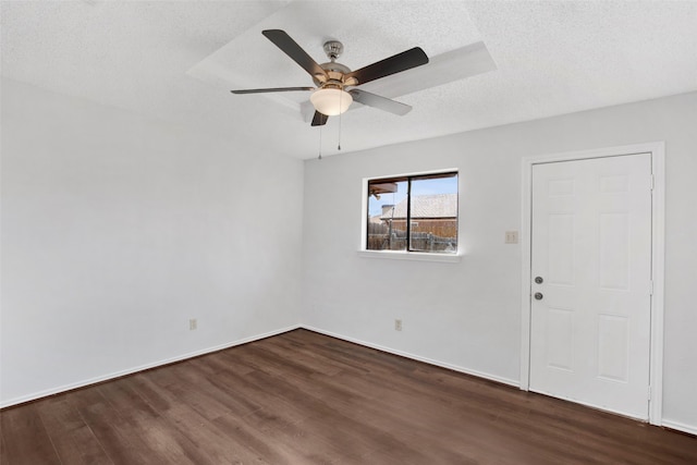 spare room with ceiling fan, dark hardwood / wood-style floors, and a textured ceiling