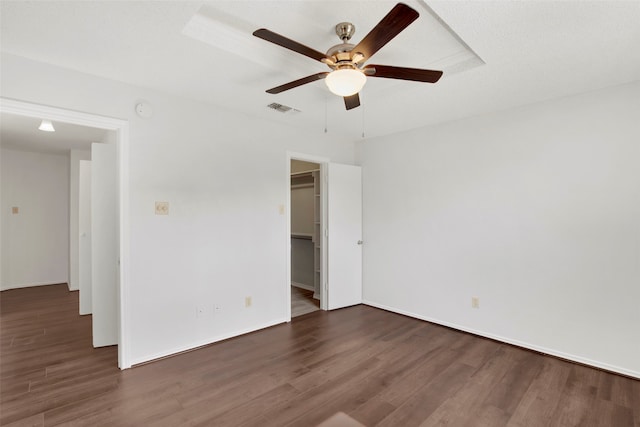 empty room featuring ceiling fan and dark hardwood / wood-style floors