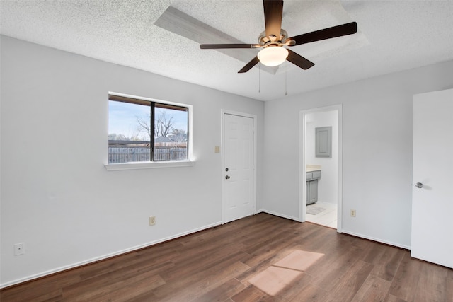 unfurnished bedroom with ensuite bathroom, ceiling fan, a textured ceiling, and dark hardwood / wood-style flooring