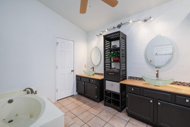 bathroom featuring a washtub, ceiling fan, vanity, vaulted ceiling, and tile patterned floors