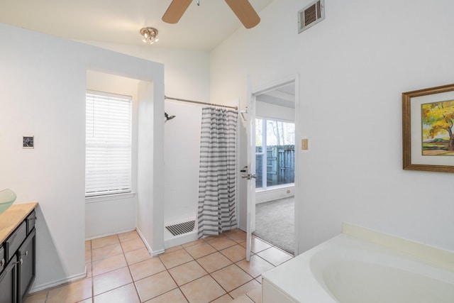 bathroom with tile patterned flooring, plus walk in shower, vanity, and ceiling fan