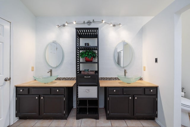 bathroom featuring tile patterned floors, vanity, and toilet