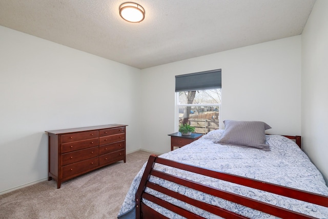 carpeted bedroom featuring a textured ceiling