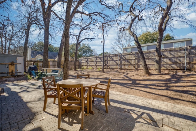 view of patio with a storage unit