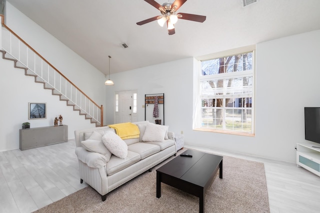 living room with ceiling fan and light hardwood / wood-style floors