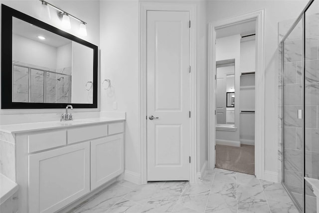 bathroom with a stall shower, marble finish floor, and vanity