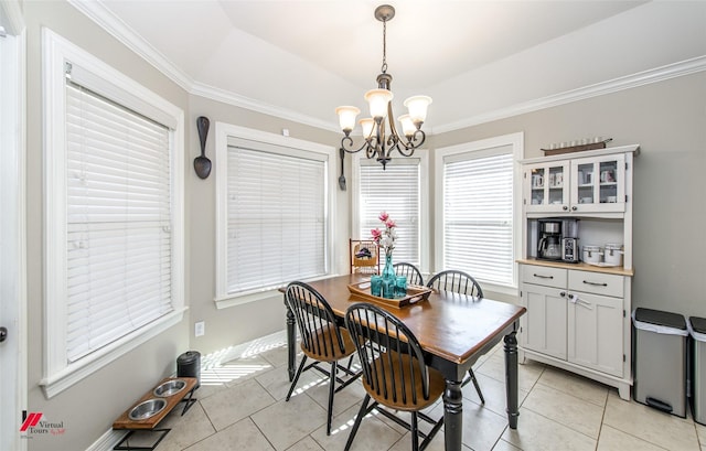 tiled dining area featuring an inviting chandelier and ornamental molding