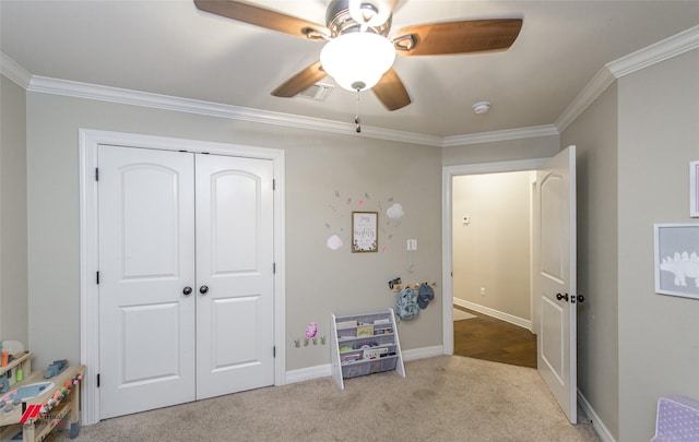 recreation room with crown molding, light carpet, and ceiling fan