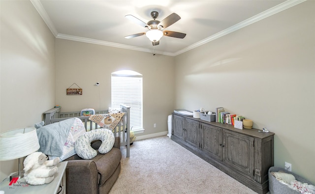 carpeted bedroom featuring crown molding and ceiling fan