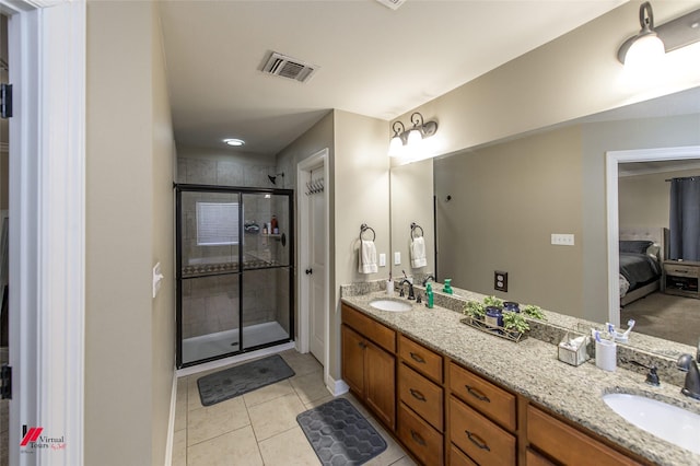 bathroom featuring tile patterned flooring, vanity, and an enclosed shower