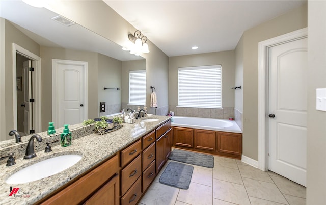 bathroom with vanity, a bath, and tile patterned flooring