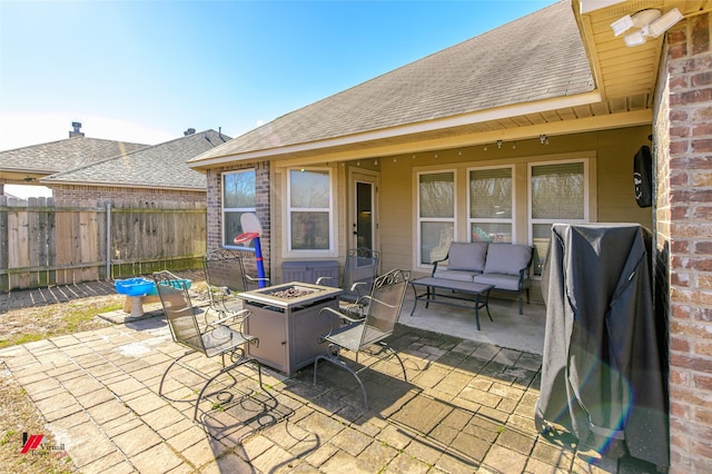 view of patio / terrace with an outdoor living space with a fire pit