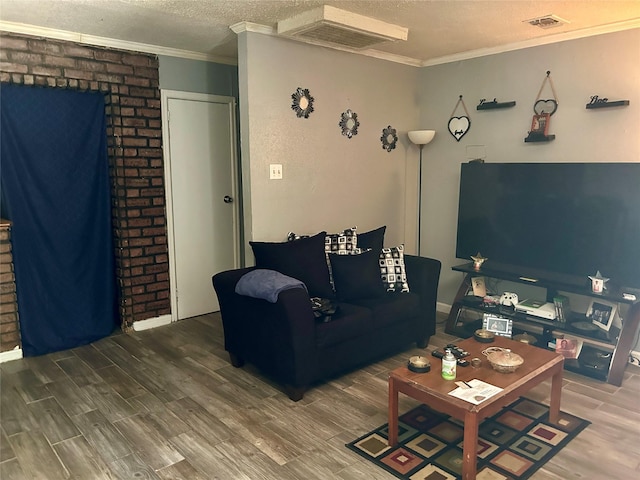 living room with wood-type flooring, crown molding, and a textured ceiling