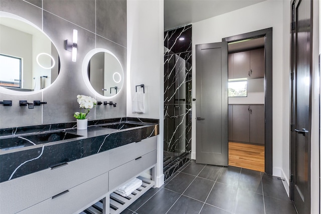 bathroom featuring vanity, tile patterned floors, and tiled shower