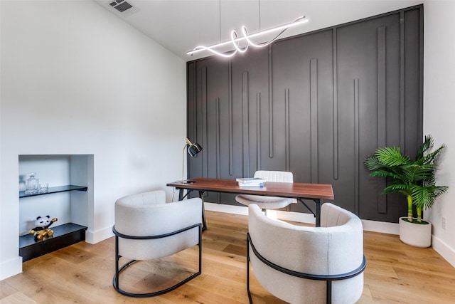 office space featuring a chandelier and light hardwood / wood-style flooring