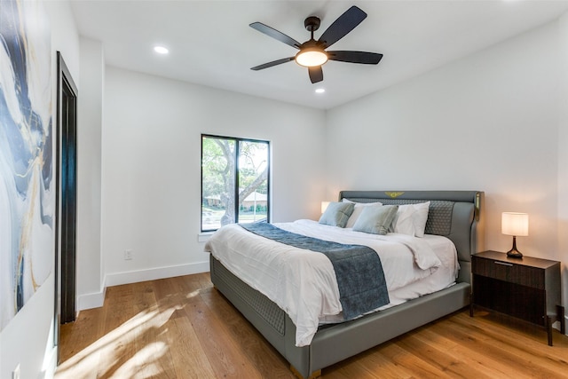 bedroom featuring ceiling fan and light hardwood / wood-style flooring