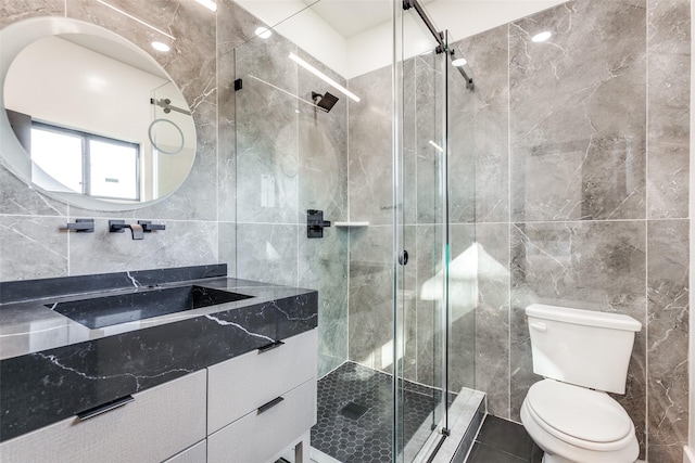 bathroom with vanity, tile walls, an enclosed shower, and toilet