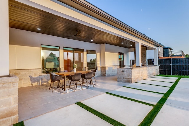 view of patio with ceiling fan and exterior bar