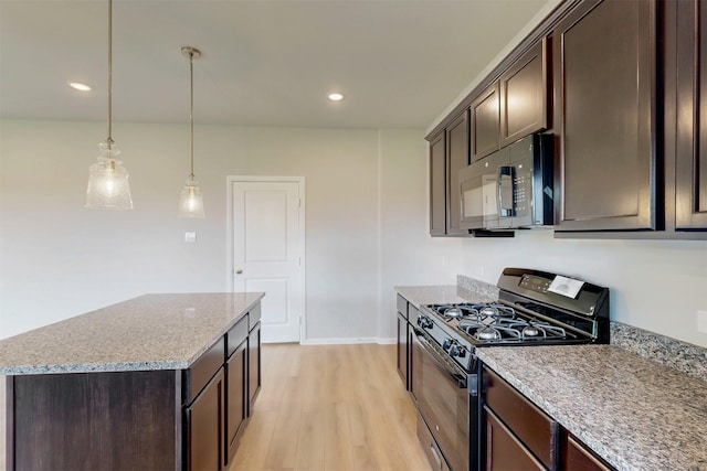 714 Gentle Bird Dr, Lavon, TX 75166 - kitchen featuring a center island, gas range, light wood-type flooring, and dark brown cabinets