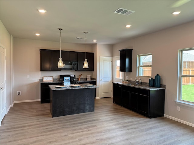 714 Gentle Bird Dr, Lavon, TX 75166 - kitchen featuring gas range oven, black microwave, a sink, stone countertops, and recessed lighting