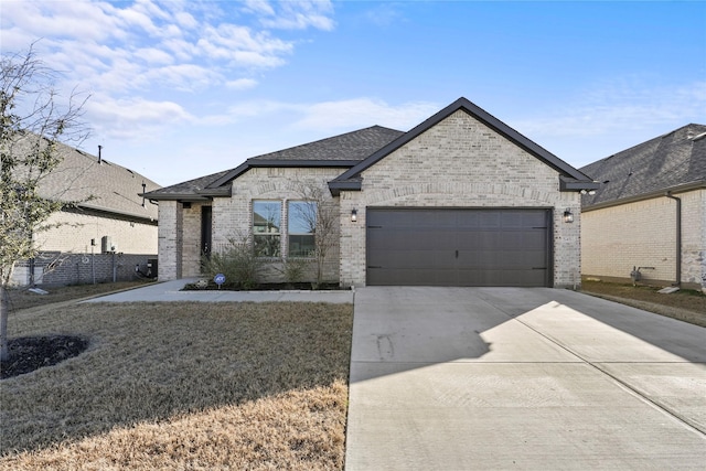 french provincial home with a garage