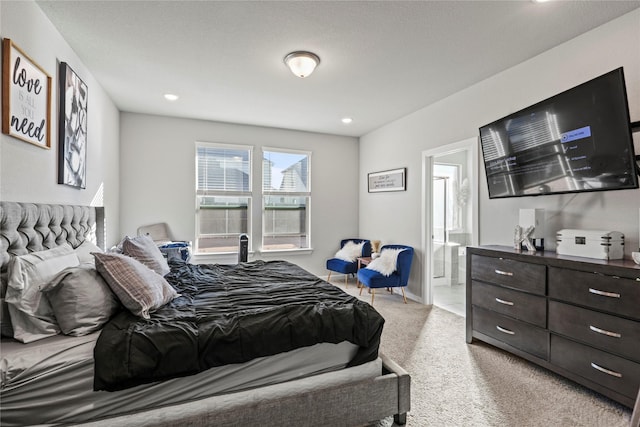 carpeted bedroom with ensuite bathroom