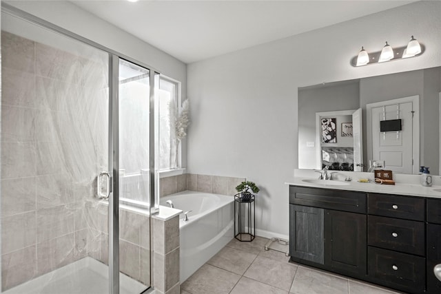 bathroom featuring vanity, tile patterned flooring, and plus walk in shower