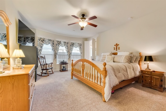 bedroom featuring light colored carpet and ceiling fan