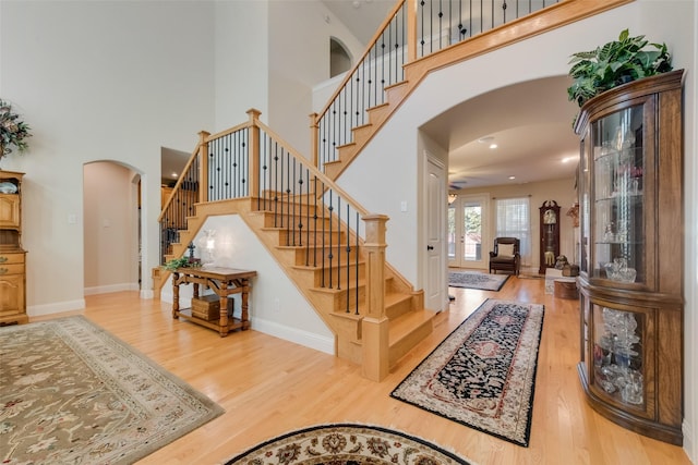 stairs featuring french doors, hardwood / wood-style floors, and a high ceiling