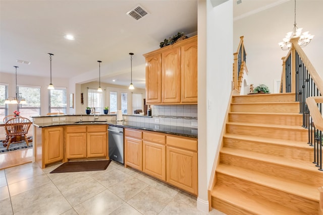 kitchen featuring pendant lighting, sink, a notable chandelier, stainless steel dishwasher, and kitchen peninsula