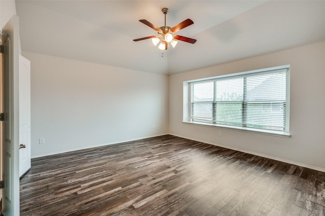 unfurnished room featuring a ceiling fan, lofted ceiling, dark wood finished floors, and baseboards